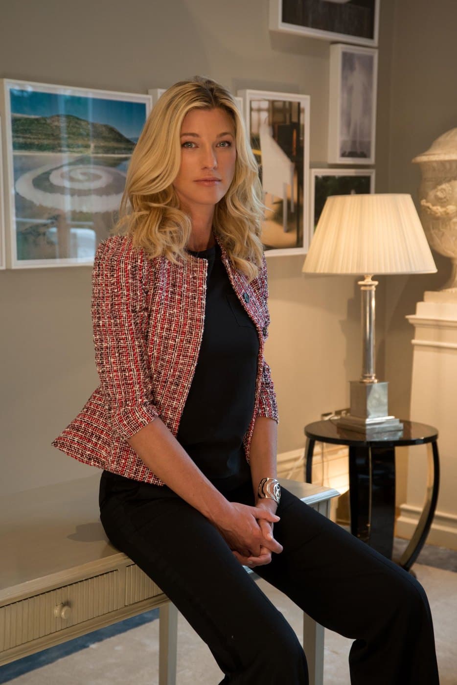 Nicole Junkermann seated in a tweed jacket in a calm room, looking towards the camera